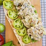 Open baguette piled high with avocado dill chicken salad and green tomatoes, recipe created by What's On Kate's Plate