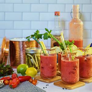 Incredibly fresh and homemade bloody mary mix with sprigs of celery and other vegetables
