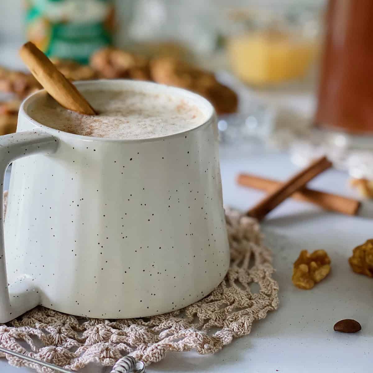 Cozy dairy free oatmeal cinnamon latte styled by food photographer with a cinnamon stick