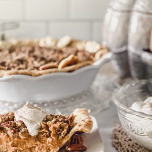 Beautiful and elegant pumpkin pie with sage pecan crumble styled in a bright white kitchen