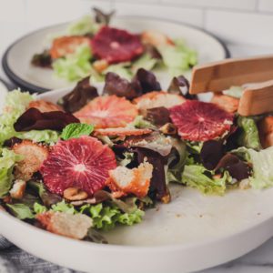 Beautiful and fresh simple salad of mixed greens and blood oranges drizzled with a lemon vinaigrette