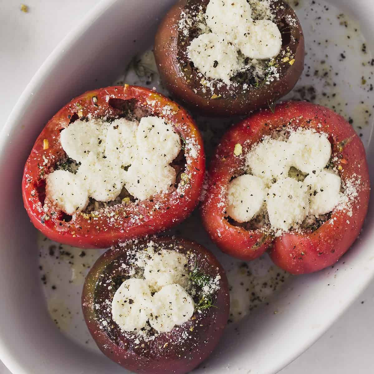 cheese stuffed tomatoes ready to bake up close