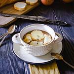 Professional photo of silky french onion soup in a white tureen